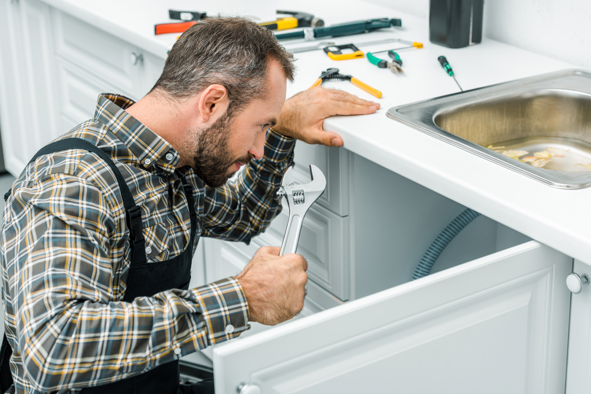 Plumbing contractor fixing leak.